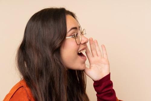 Teenager,Girl,With,Coat,Shouting,With,Mouth,Wide,Open